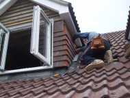 Tiler working on roof.JPG